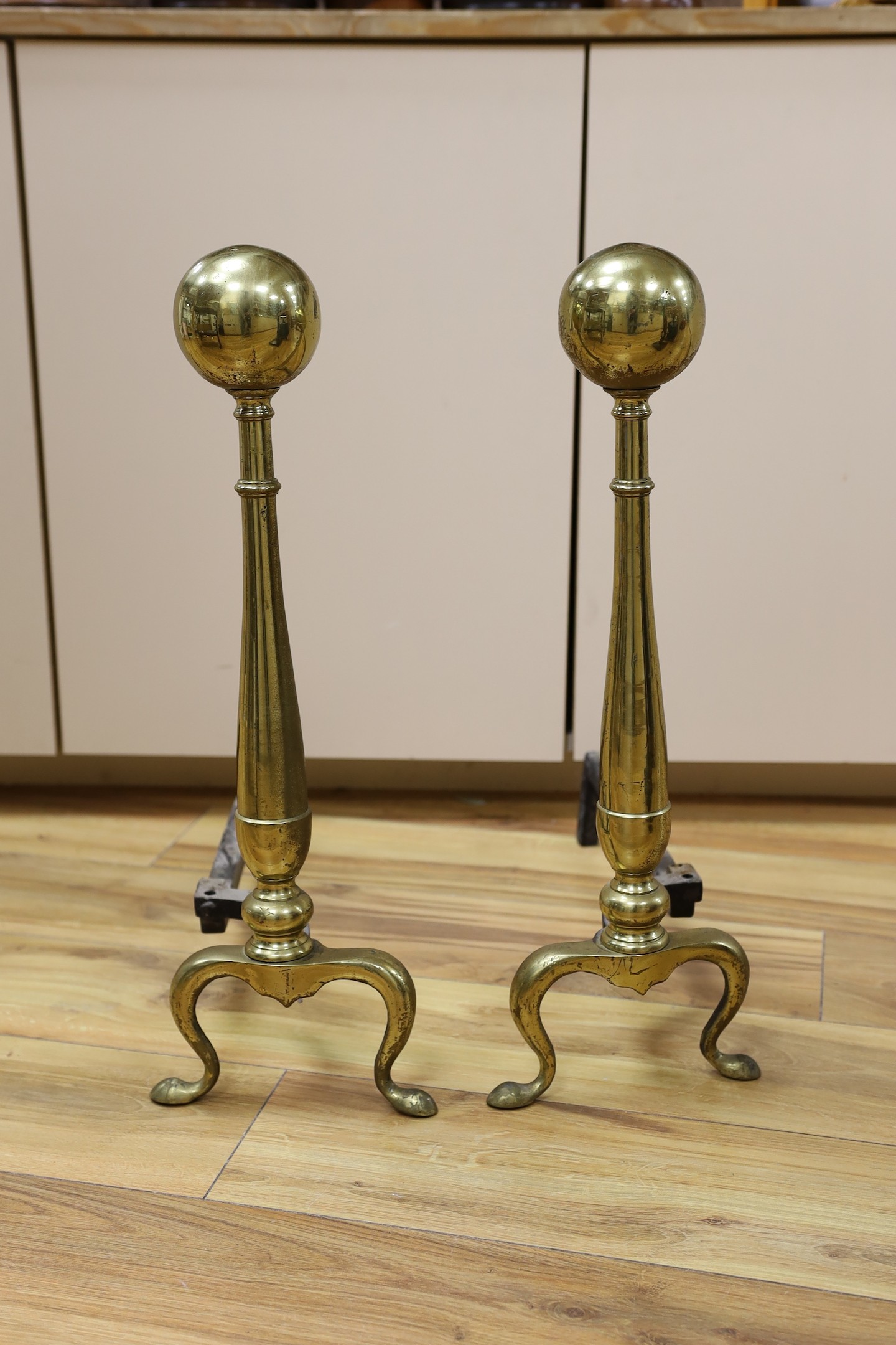 A pair of brass andirons. 57cm high